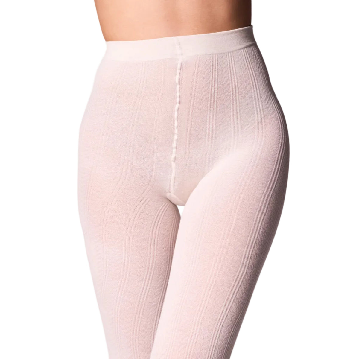 A close-up of a model wearing high-waisted, ribbed tights in a off white colour shown against a white background.