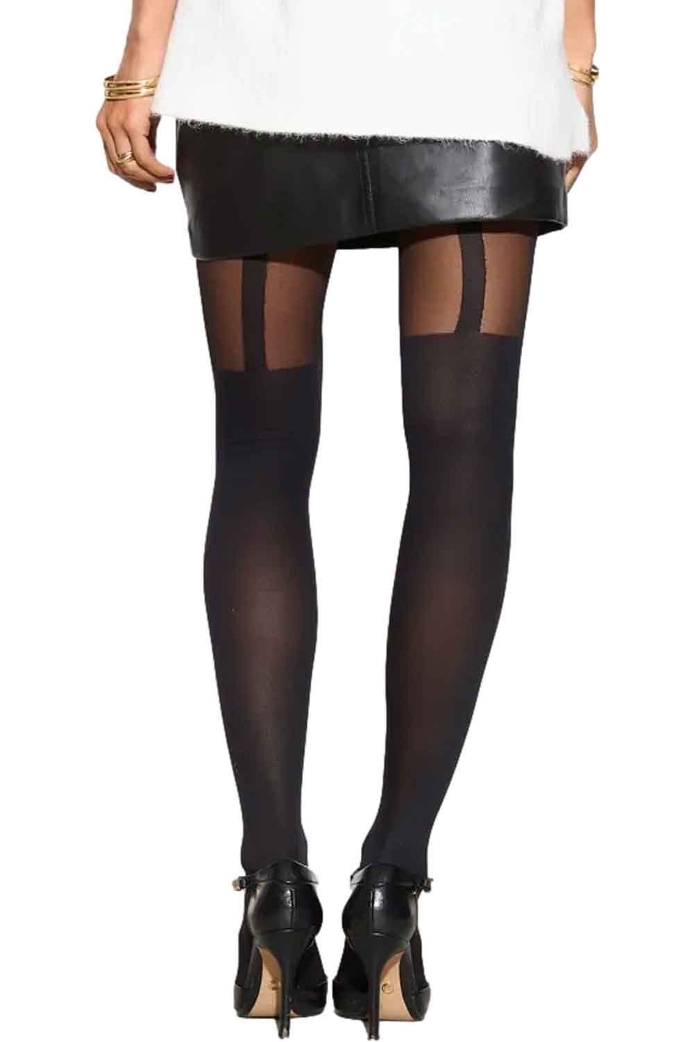 Model wearing black mock suspender tights with a white top and black shoes on a white background