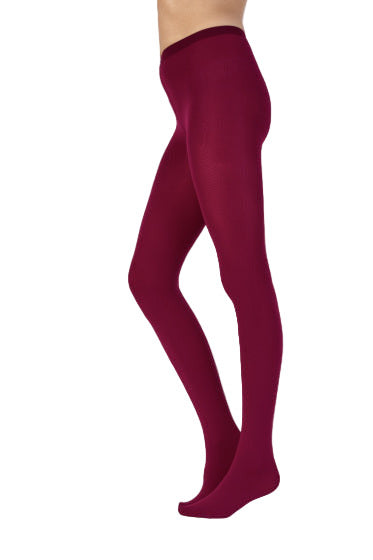 Cherry coloured tights worn by a person on a white background