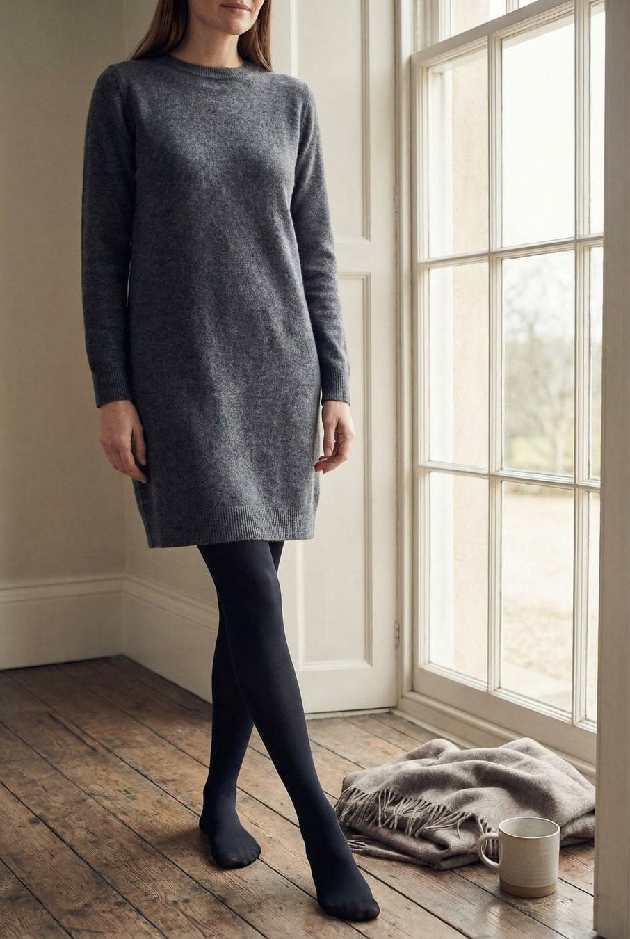 Model wearing grey jumper dress and 80 denier tights