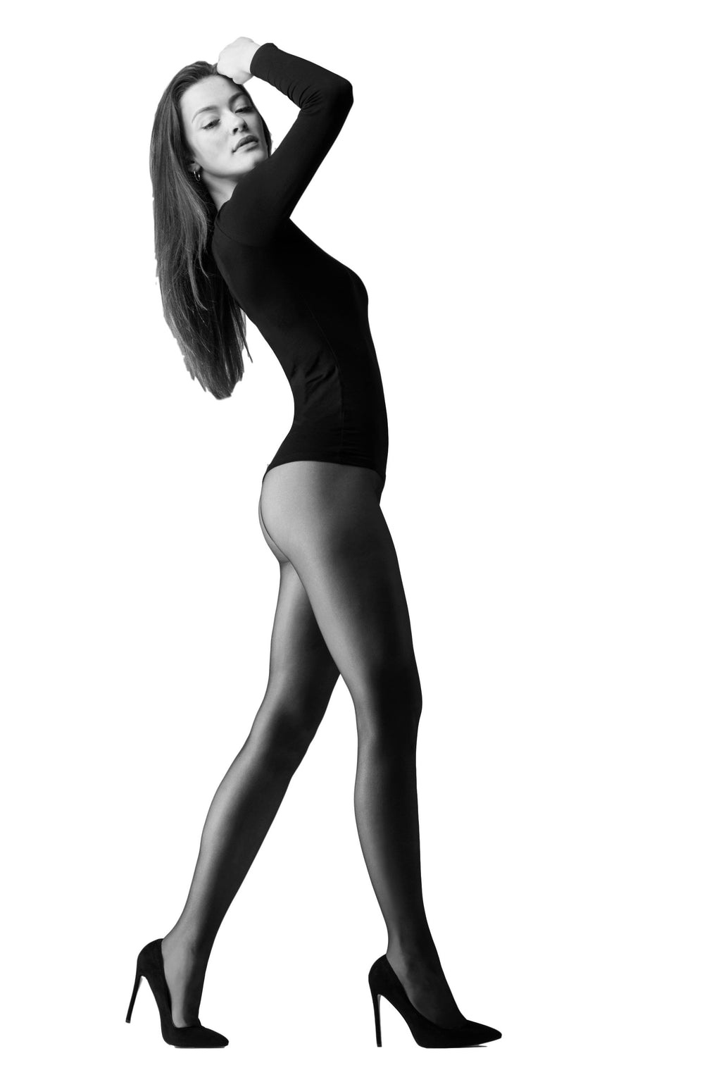 Black and white image of a person wearing black tights and high heels on a white background