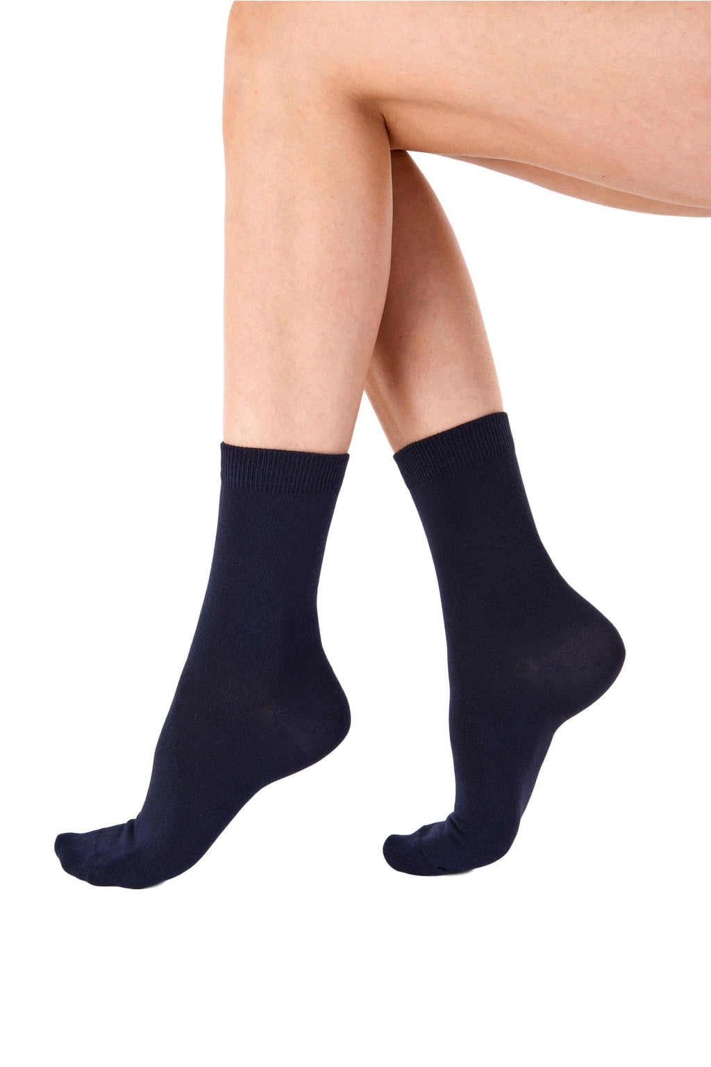 Navy blue socks worn by a person on a white background