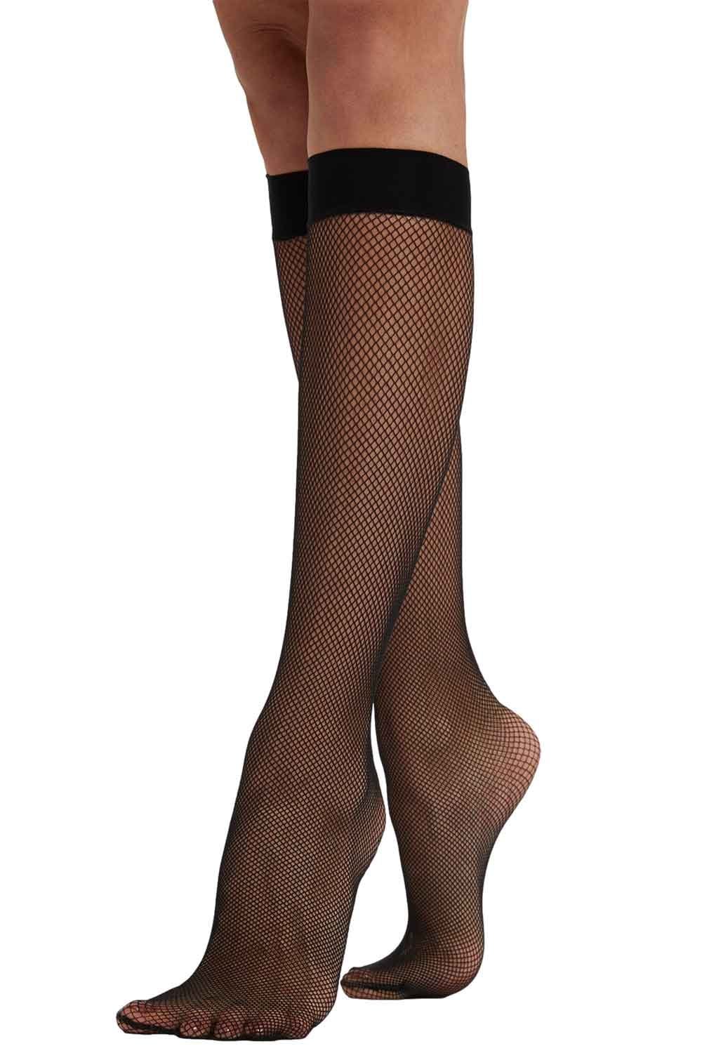 Black fishnet knee highs worn by a model on a white background