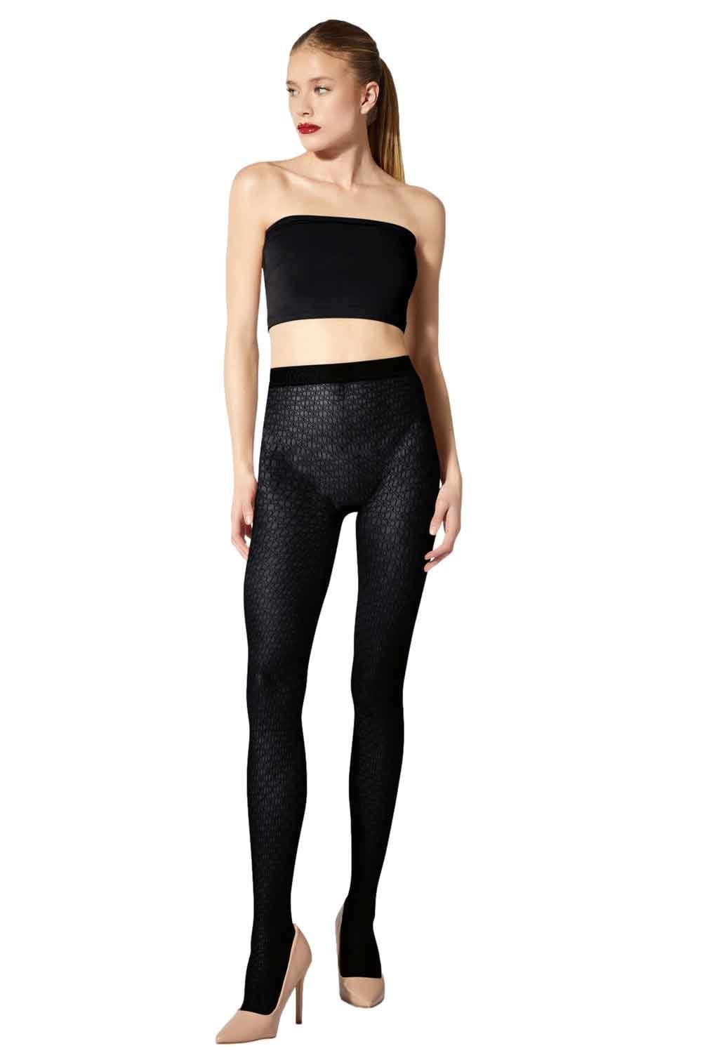 Model wearing black net motif tights on a white background