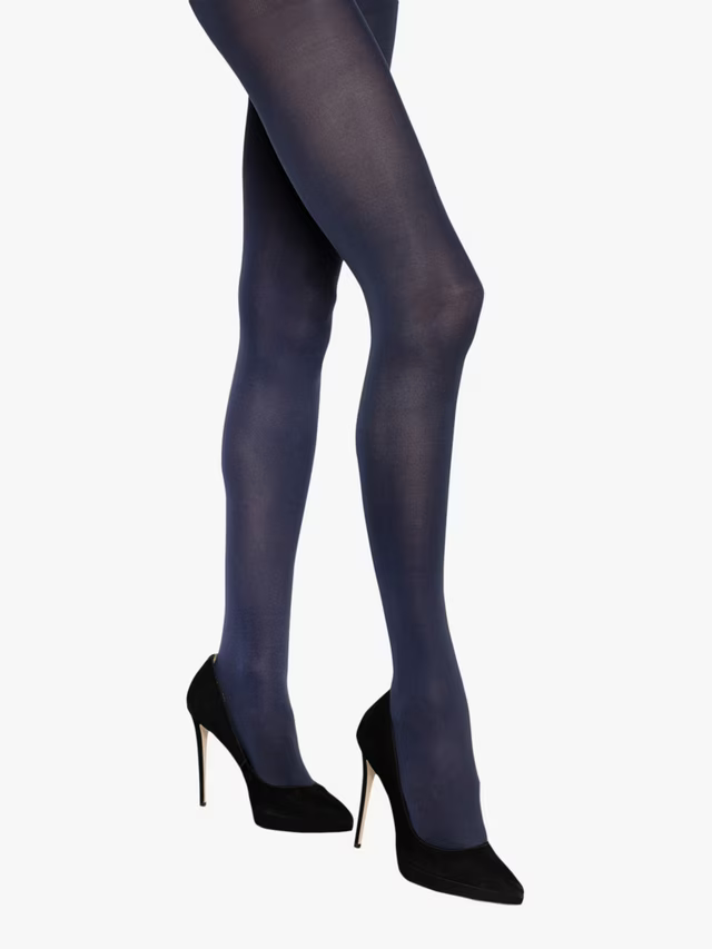 Charnos navy tights worn with black high-heeled shoes on a white background