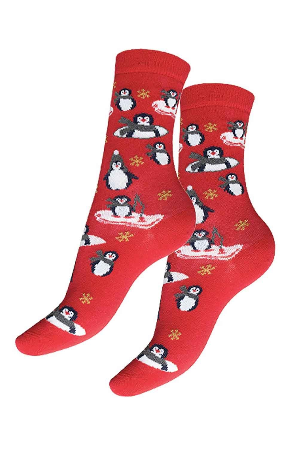 Red socks with penguin design on a white background