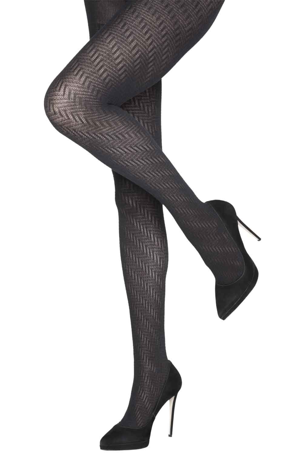Black zig zag  patterned tights worn with black high-heeled shoes on a white background