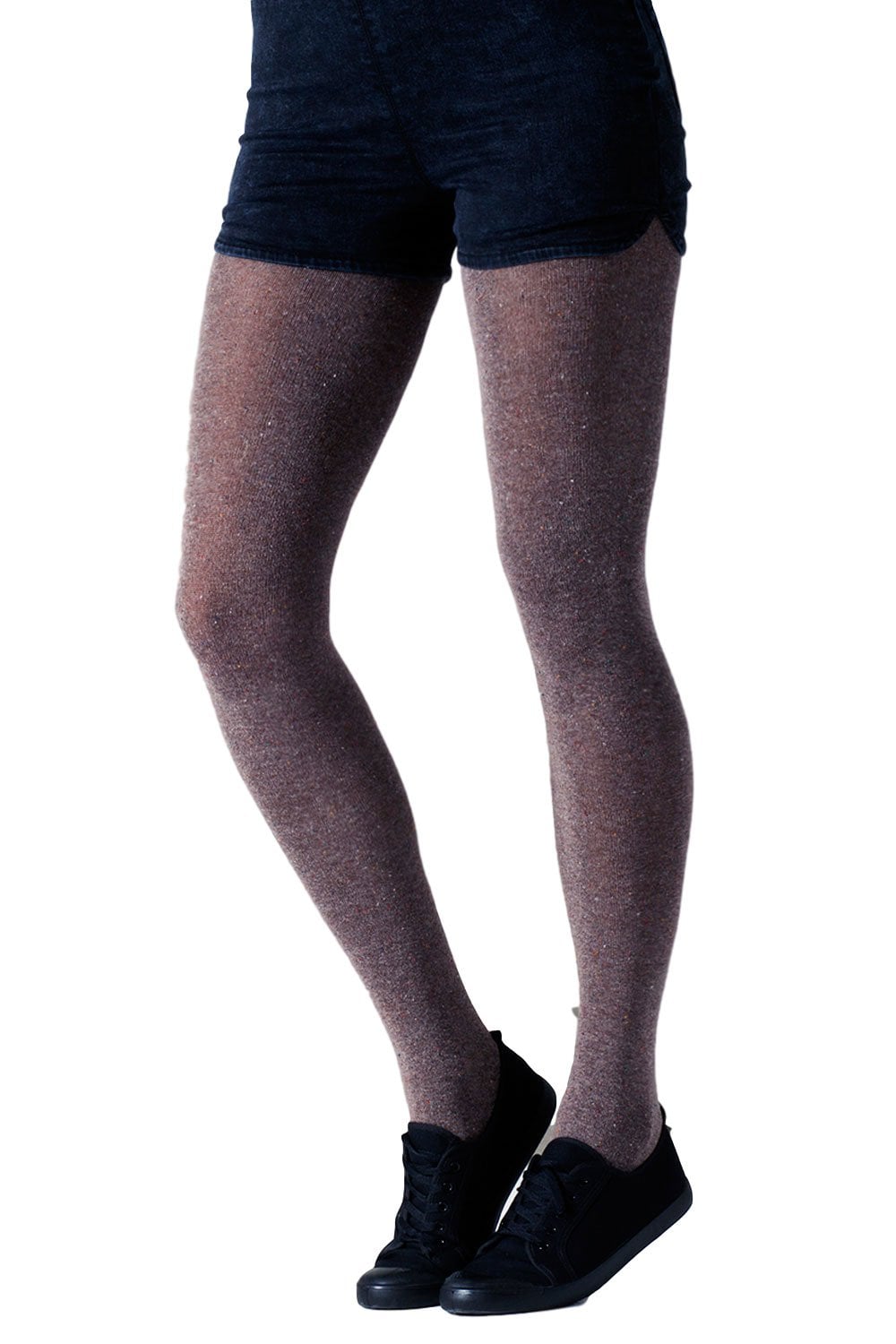Model wearing speckled patterned  tights and black shoes on a white background