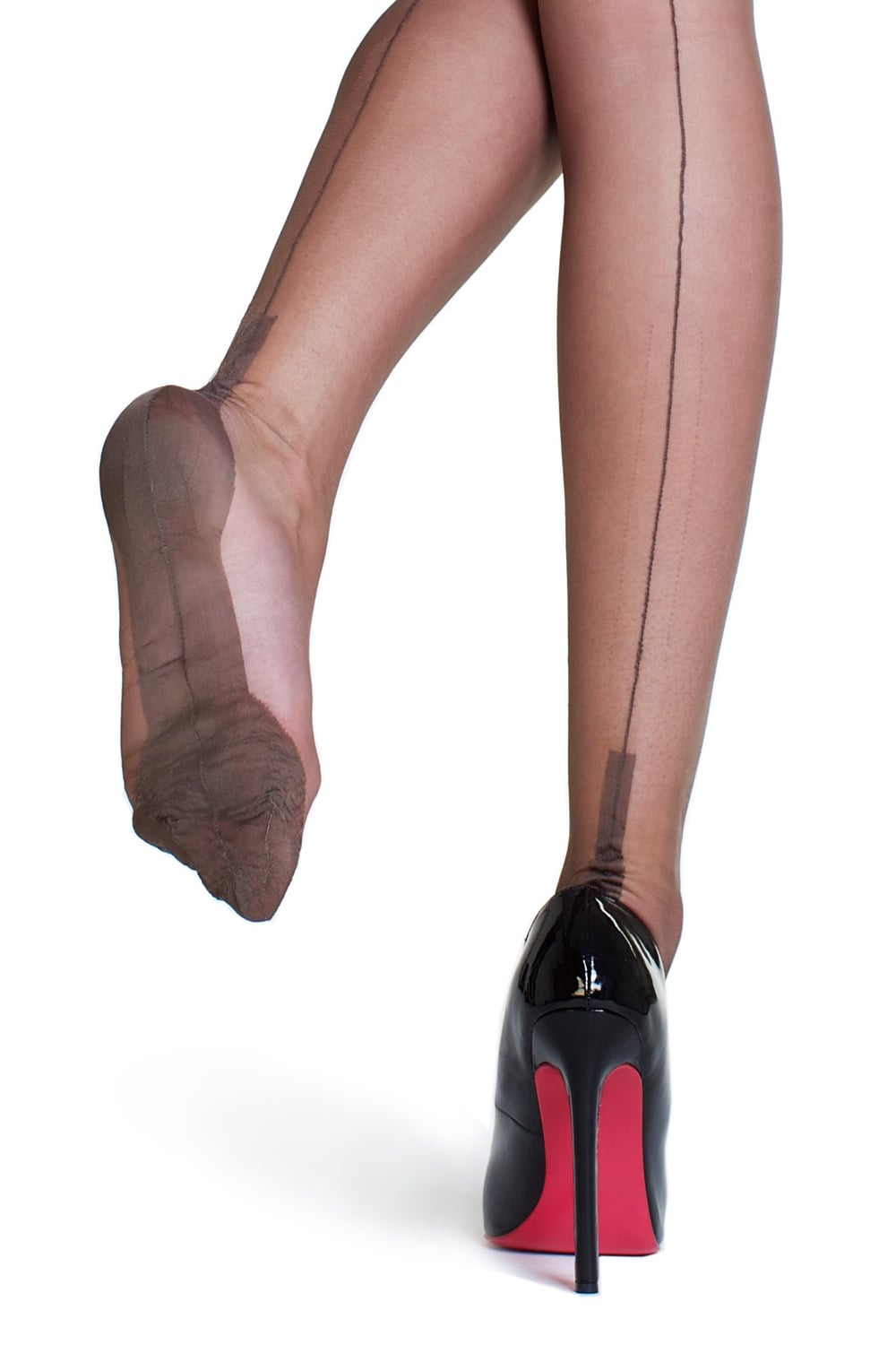 Black high-heeled shoes with red soles worn with sheer seamed bronze stockings on a white background