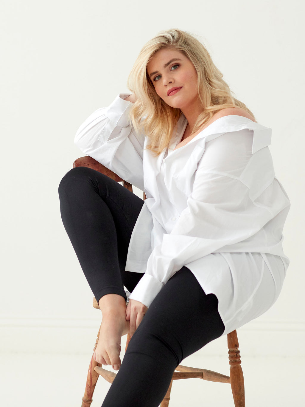 Model wearing black leggings on a white background