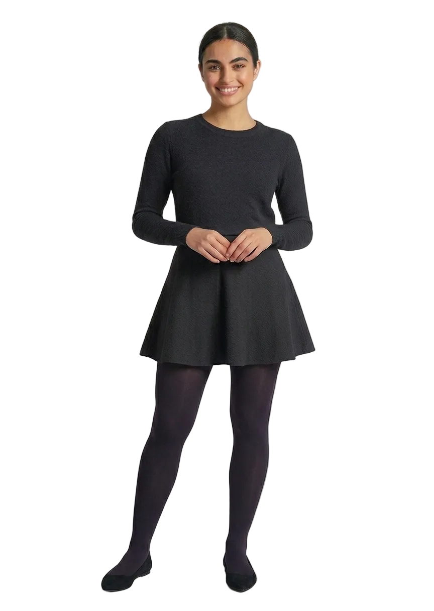 Woman wearing a black dress and dark aubergine tights