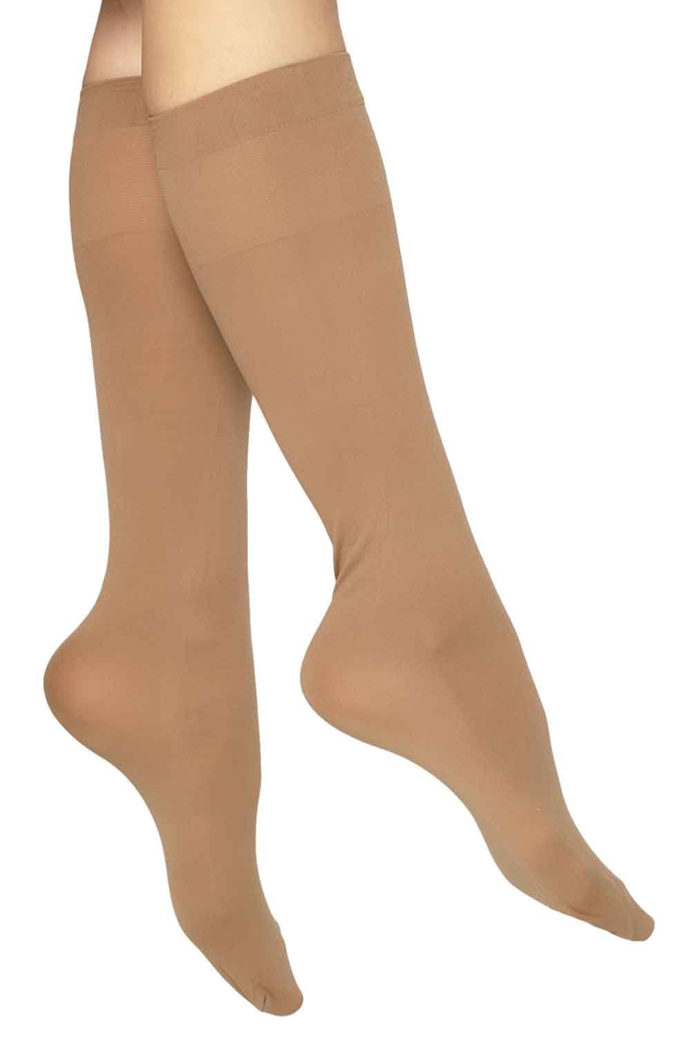 Natural coloured knee-high socks on a white background