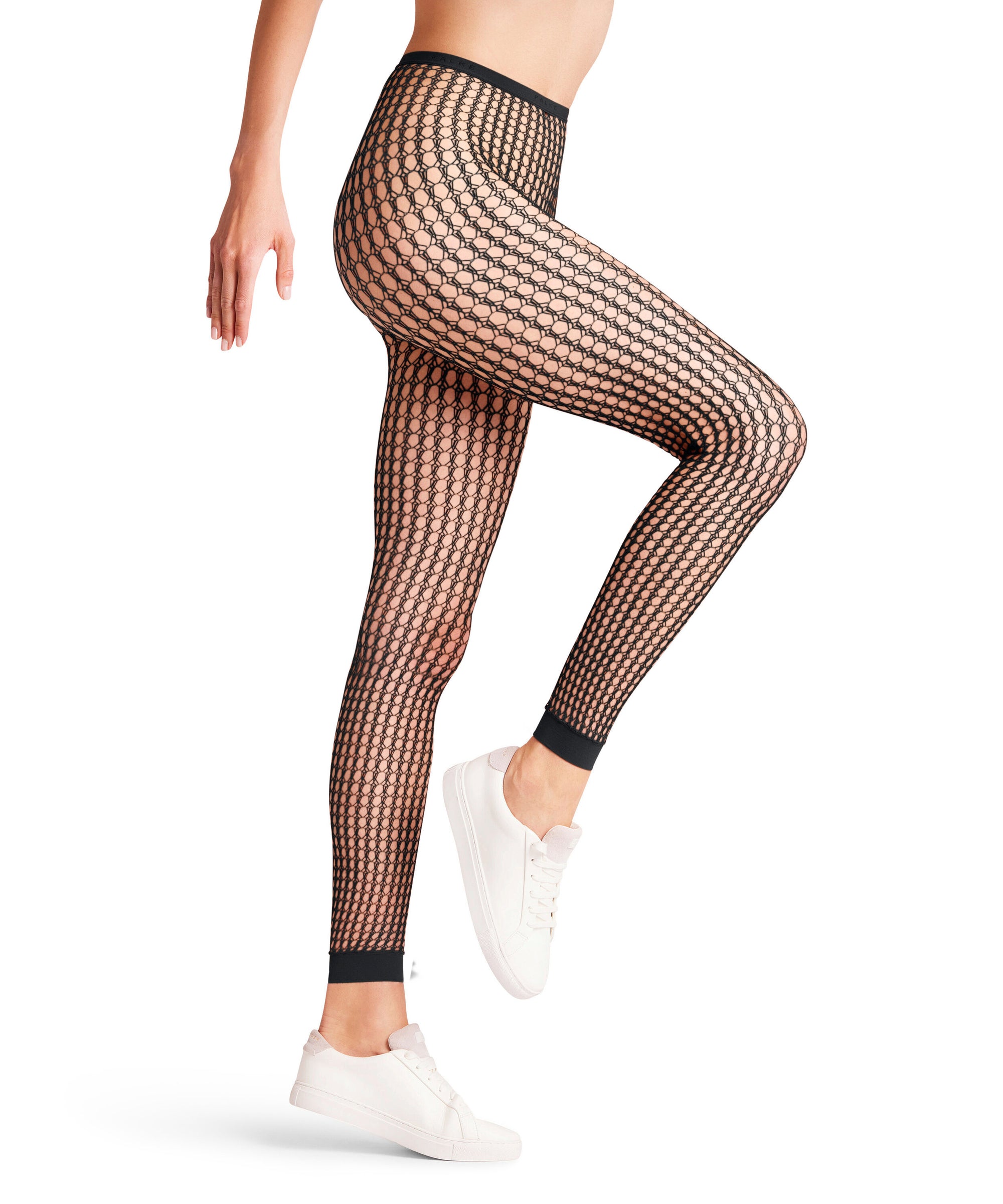 Black fishnet footless tights worn by a person on a white background