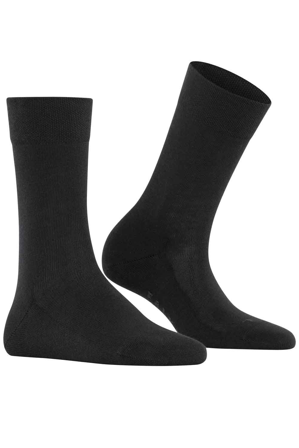Two Falke black socks on a white background