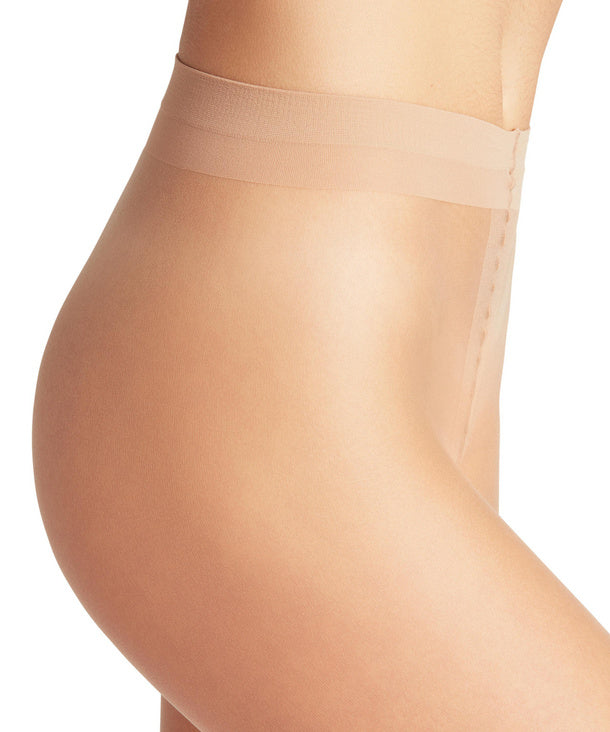 Golden sheer tights being worn on a white background