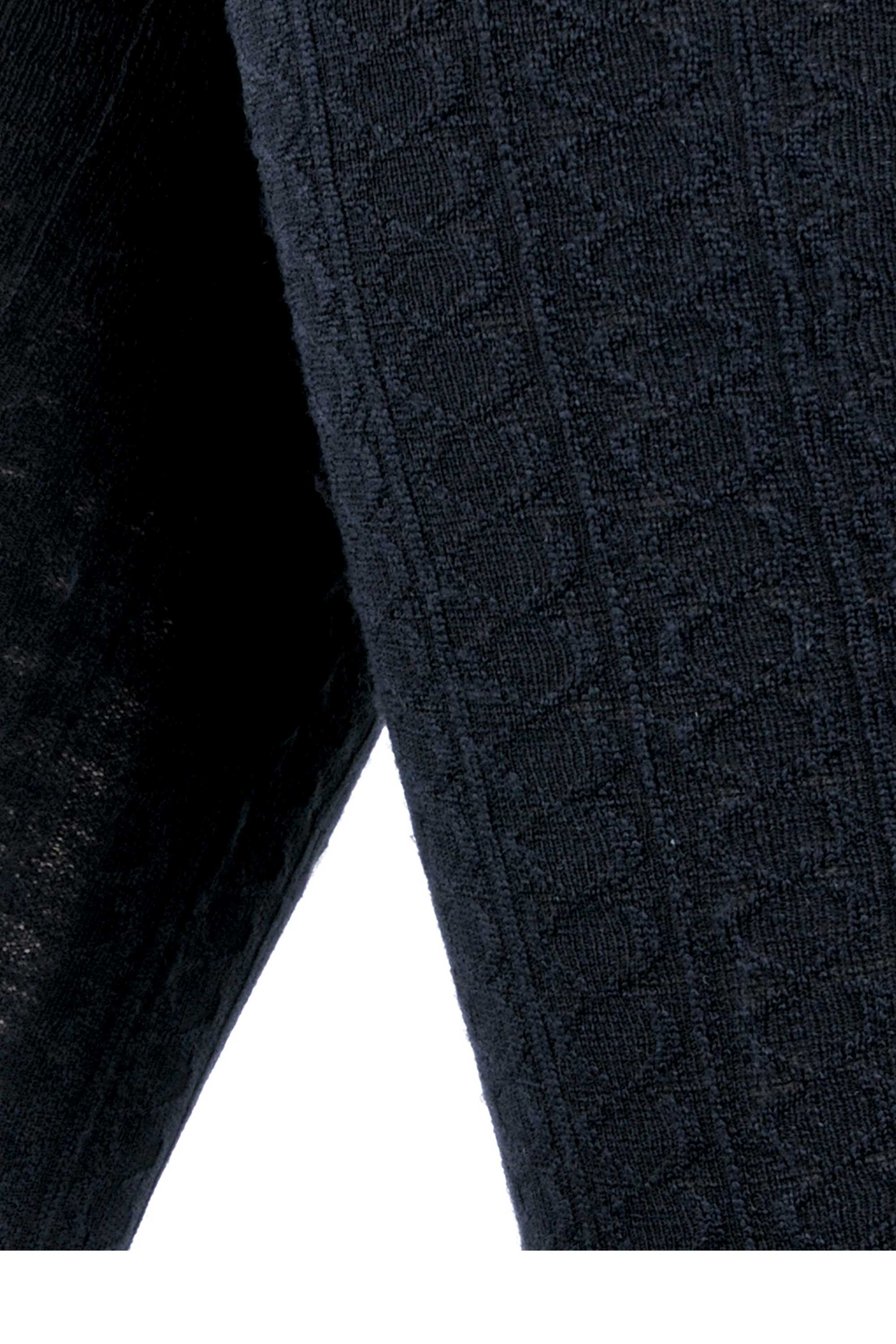 Close-up of a textured black cable fleece fabric with a subtle pattern on a white background