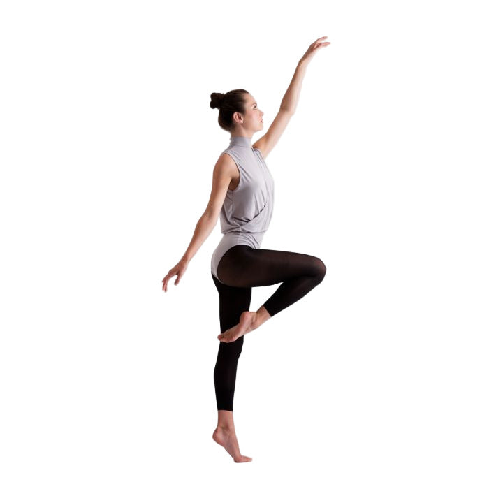 Dancer in a grey  top and black footless dance tights  posing on a white background
