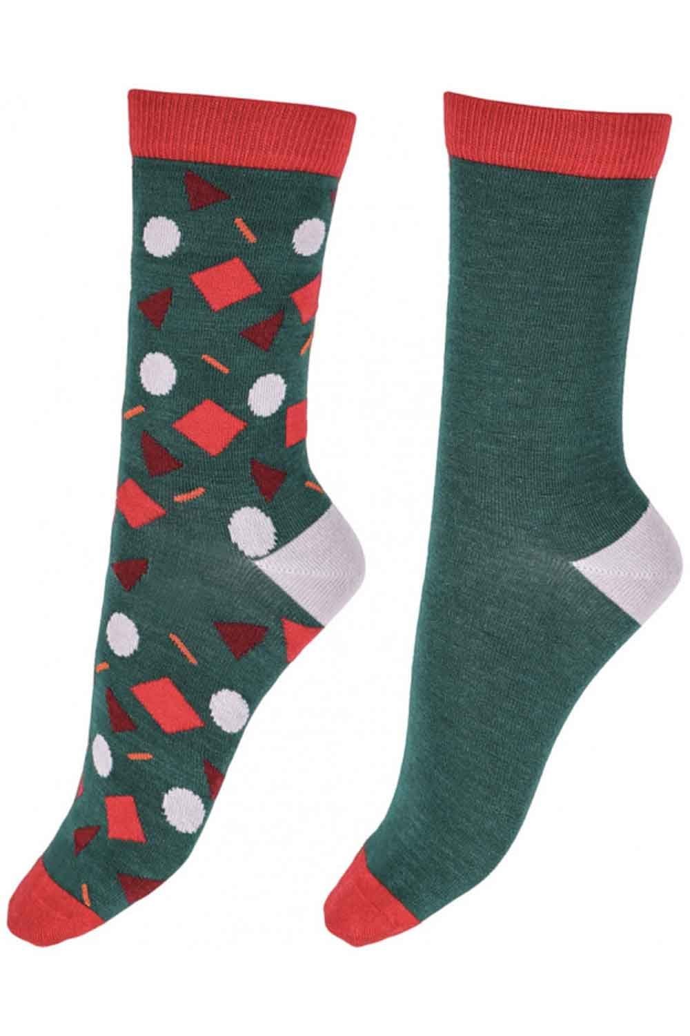 Two green socks one  with red and white funfetti pattern on a white background