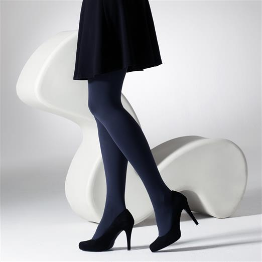 Person wearing navy tights and black high heels on a white background
