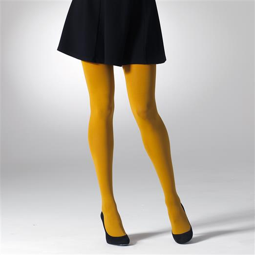 Person wearing mustard yellow tights and black shoes on a white background
