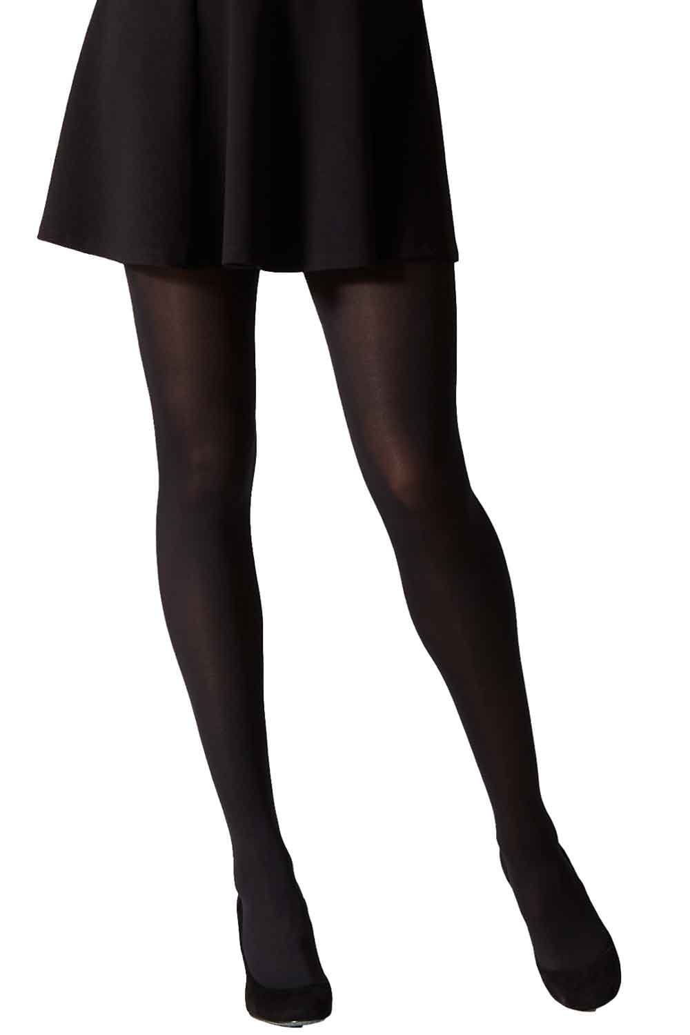 Model  wearing black opaque tights and a black skirt on a white background