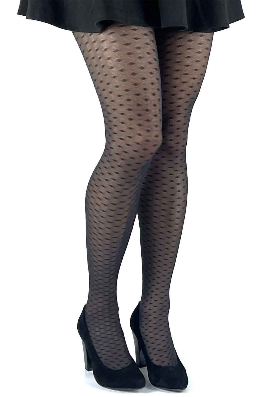 Black lace effect  patterned tights worn with a black skirt and shoes on a white background