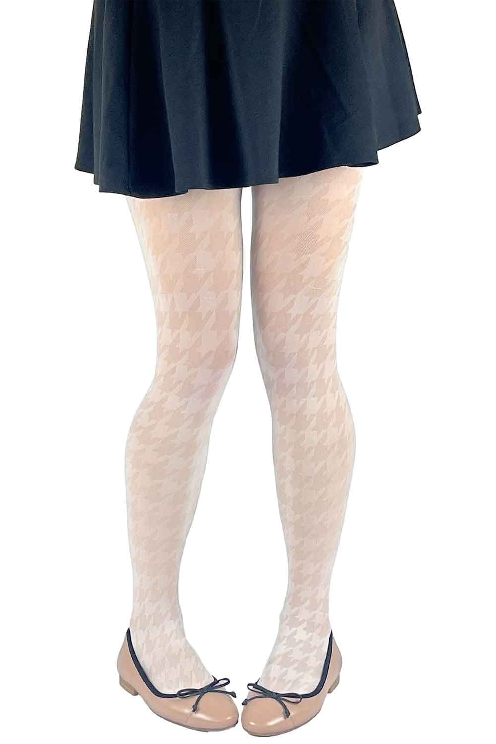 Model wearing cream patterned  tights with a black skirt and beige shoes on a white background