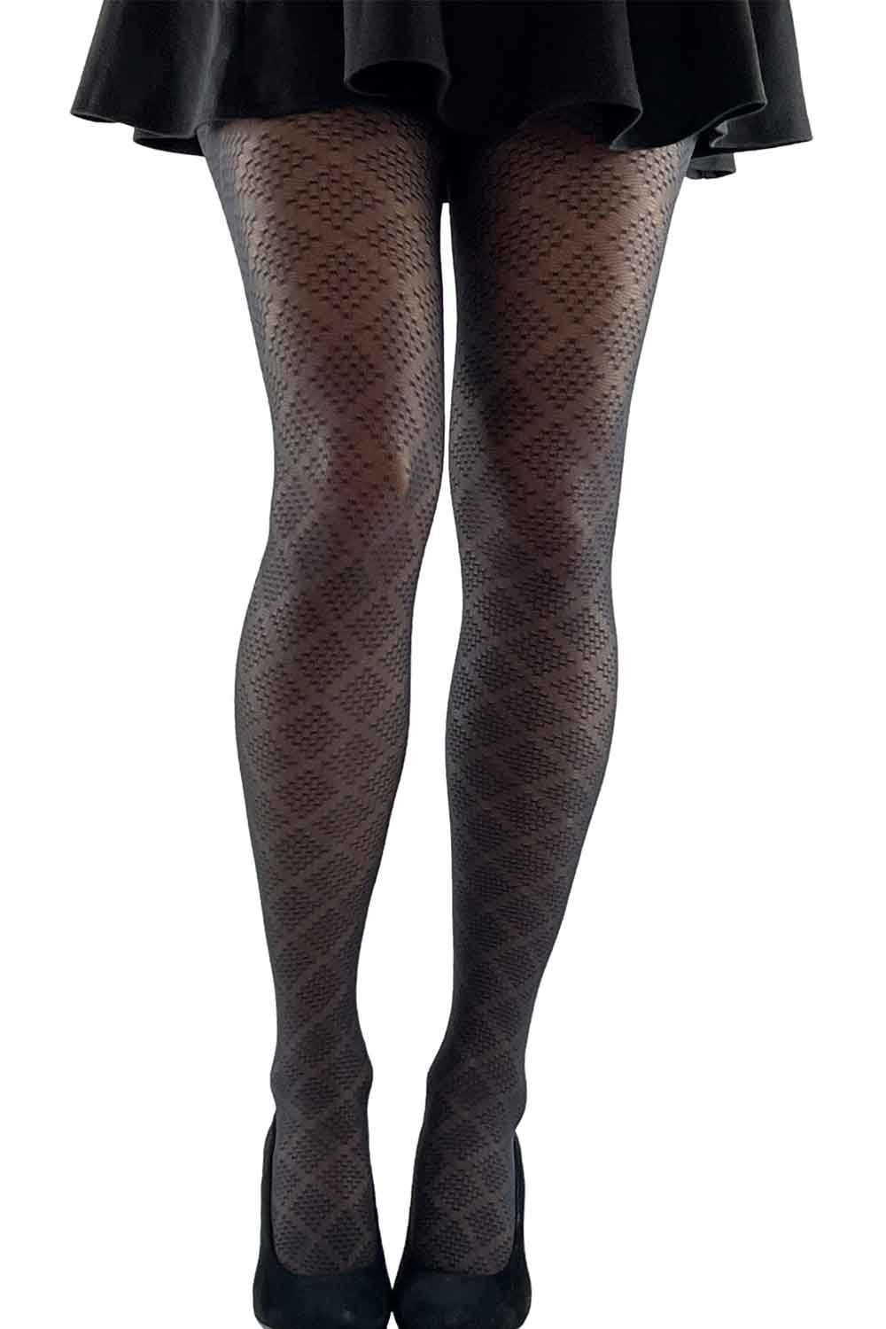 Black diamond patterned  tights worn with a black skirt on a white background