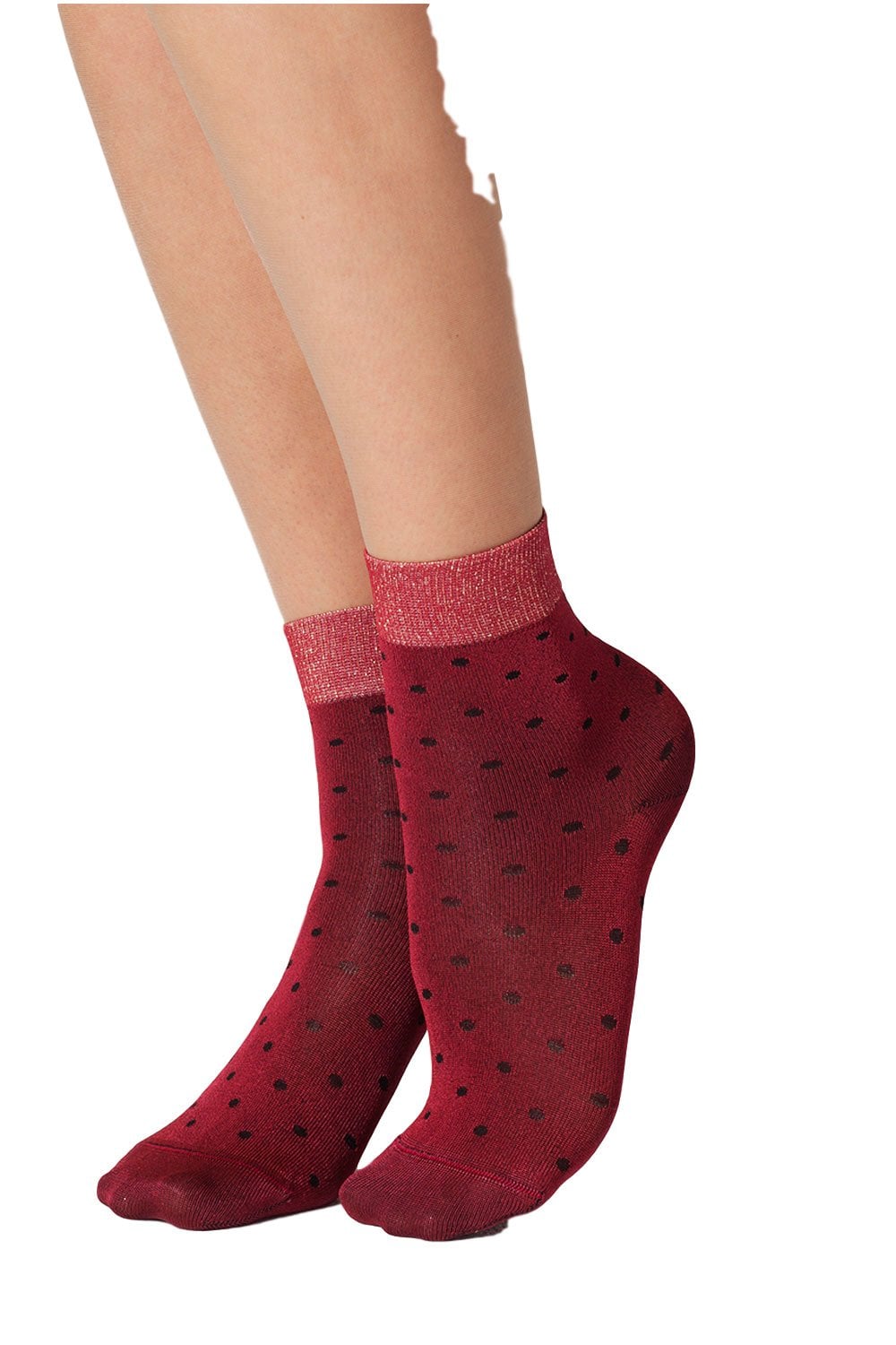 Ruby red socks with black polka dots worn by a model on a white background