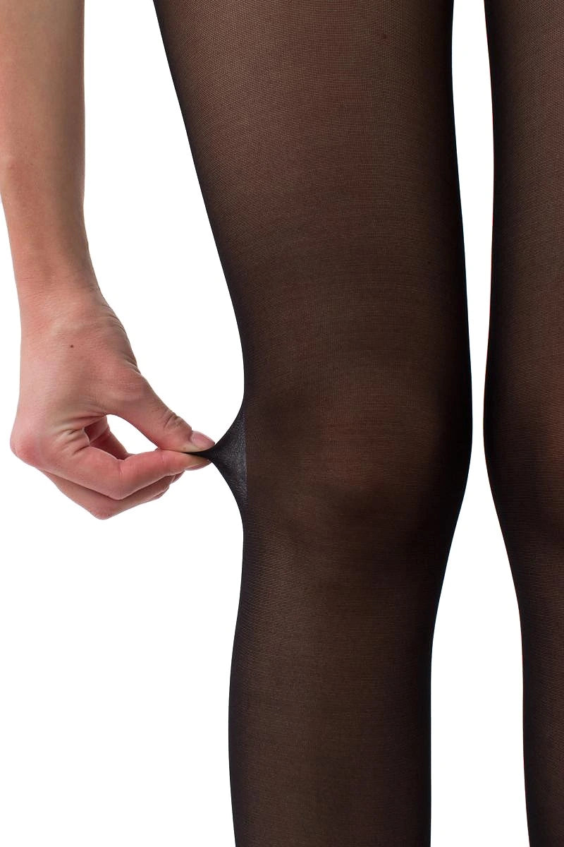 A close-up of a person's leg wearing sheer black tights, with a hand pulling the fabric slightly to show the stretch and transparency of the hosiery.