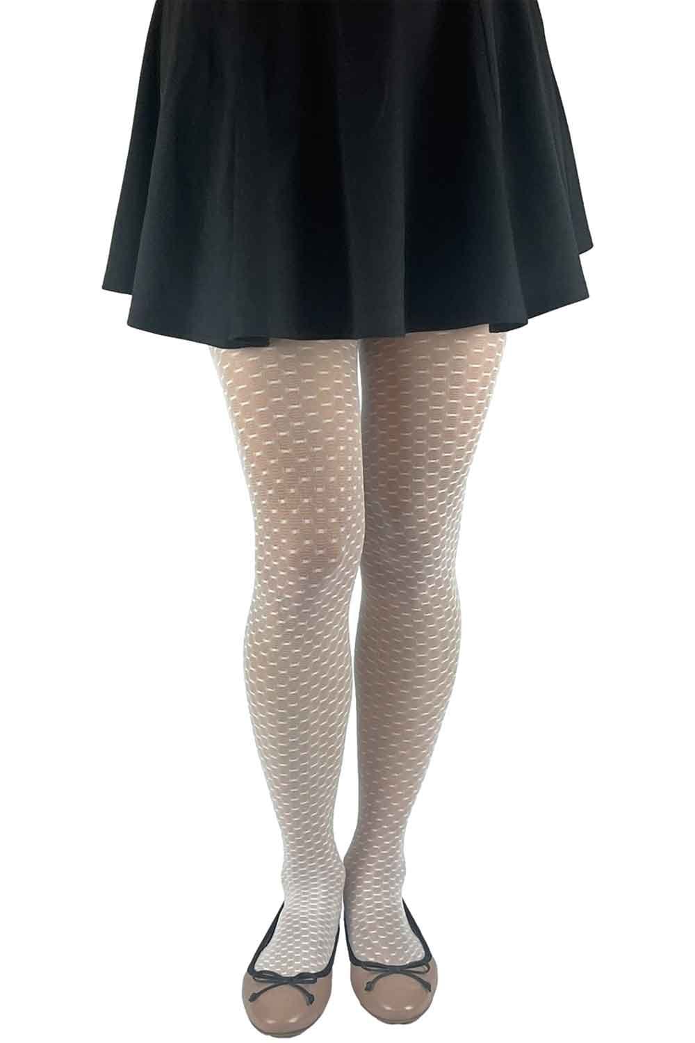 Model wearing a black skirt and cream patterned tights on a white background