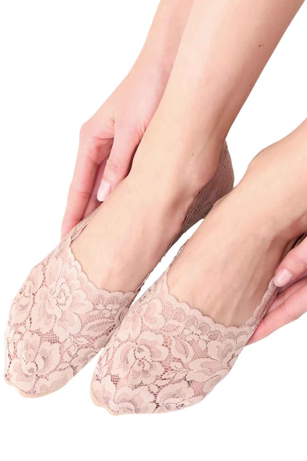 Cosmetic coloured lace socks being worn on a white background