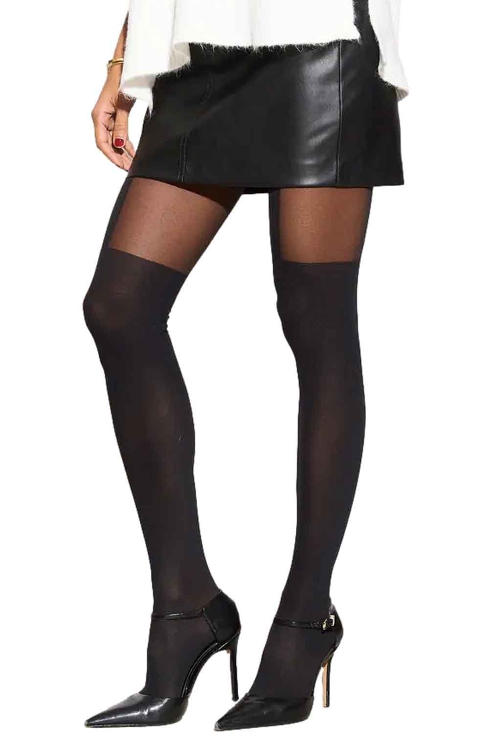 Model wearing black leather skirt and black mock suspender tights  on a white background