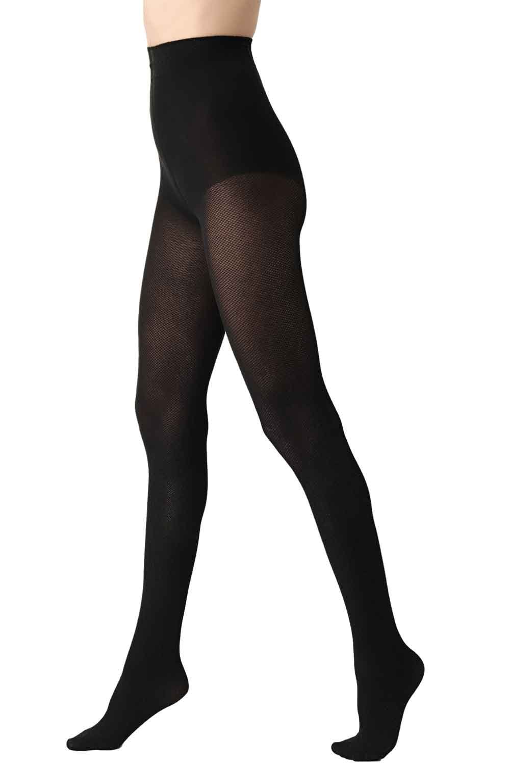 Black opaque tights worn by a person on a white background