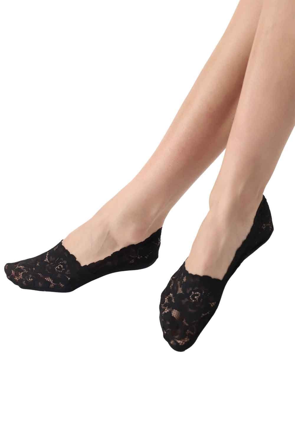Black lace socks worn by a person on a white background