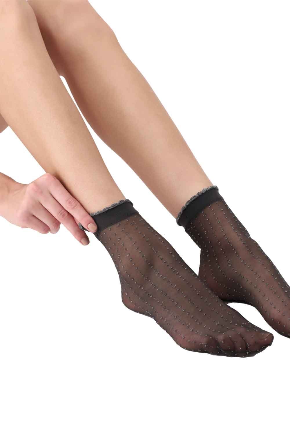 Black/gold  socks worn by a person on a white background