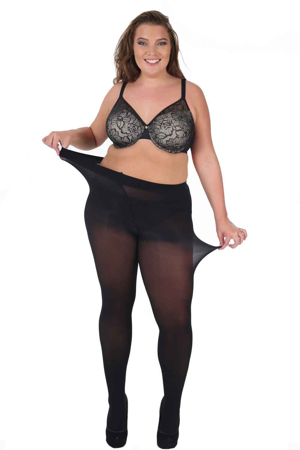 Woman wearing a black lace bra and opaque plus size super stretch tights on a white background