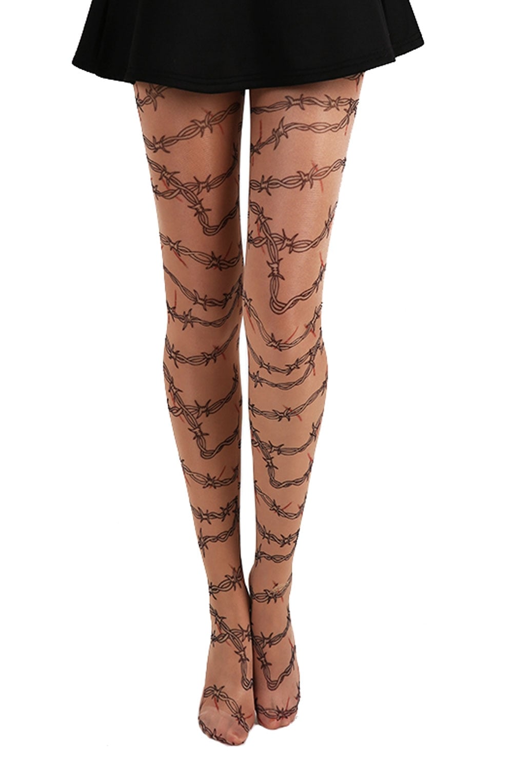 Barbed wire patterned tights worn with a black skirt on a white background