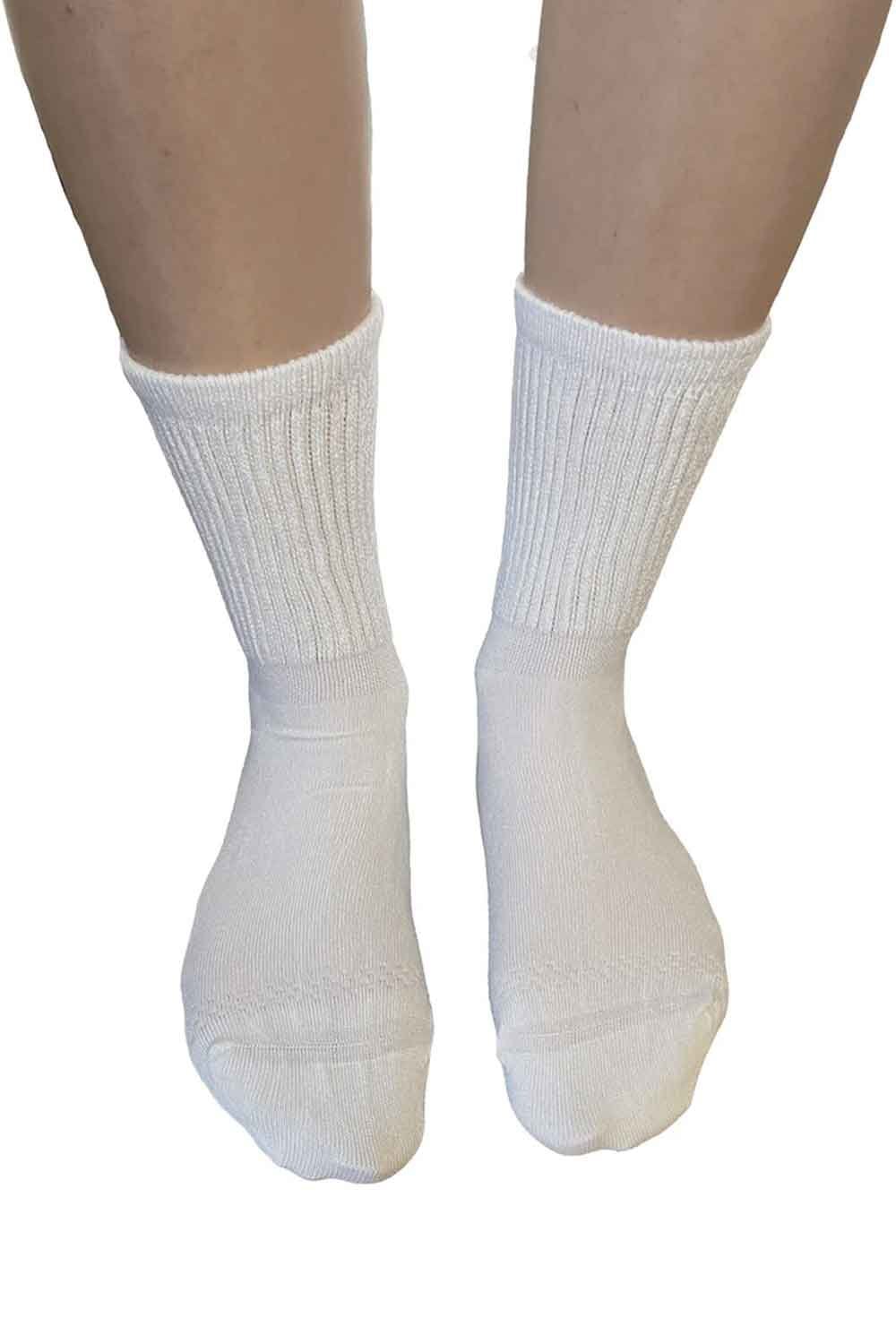Extra wide bamboo super soft white socks worn on a white background