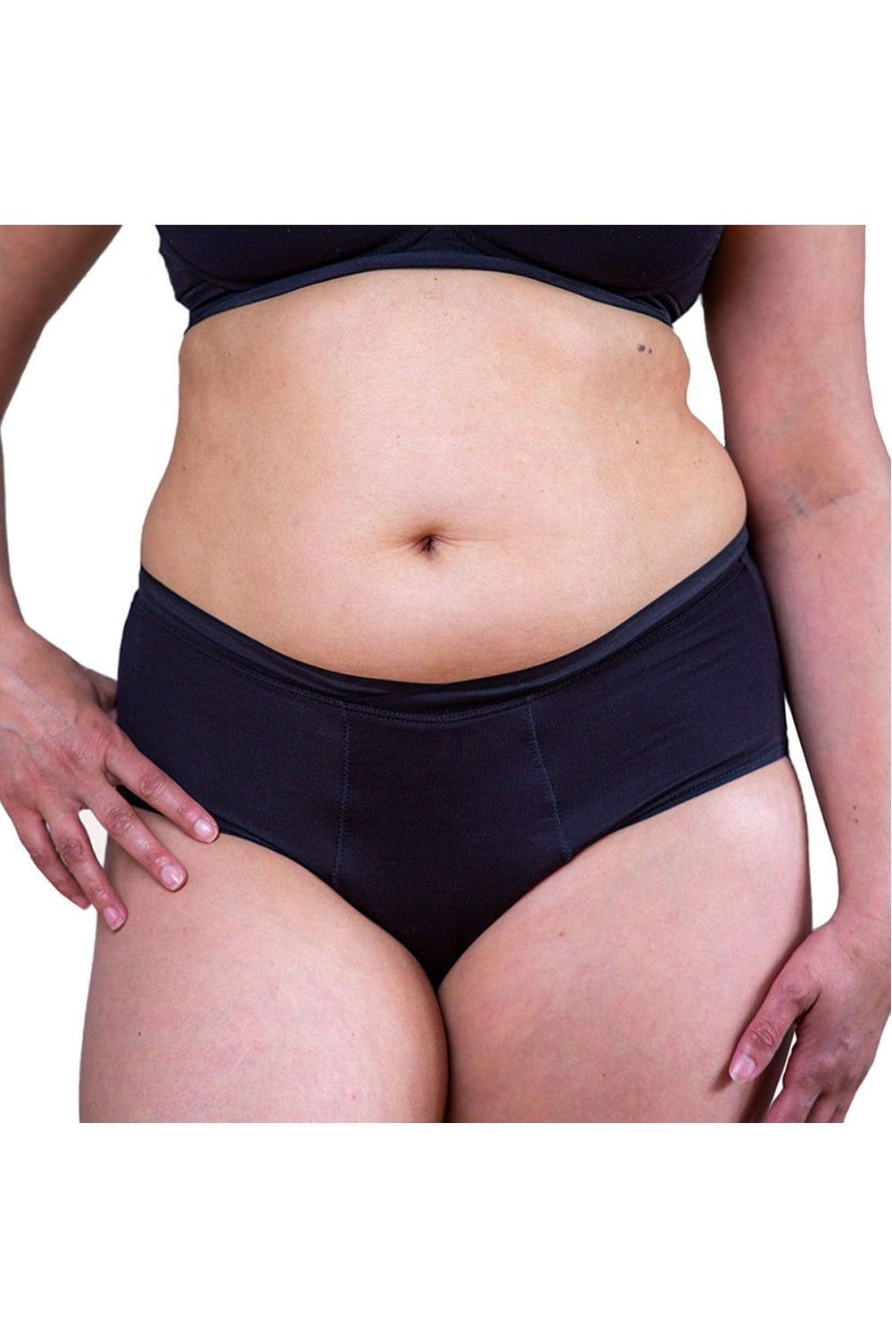 Person wearing black period high waisted bamboo briefs on a plain background