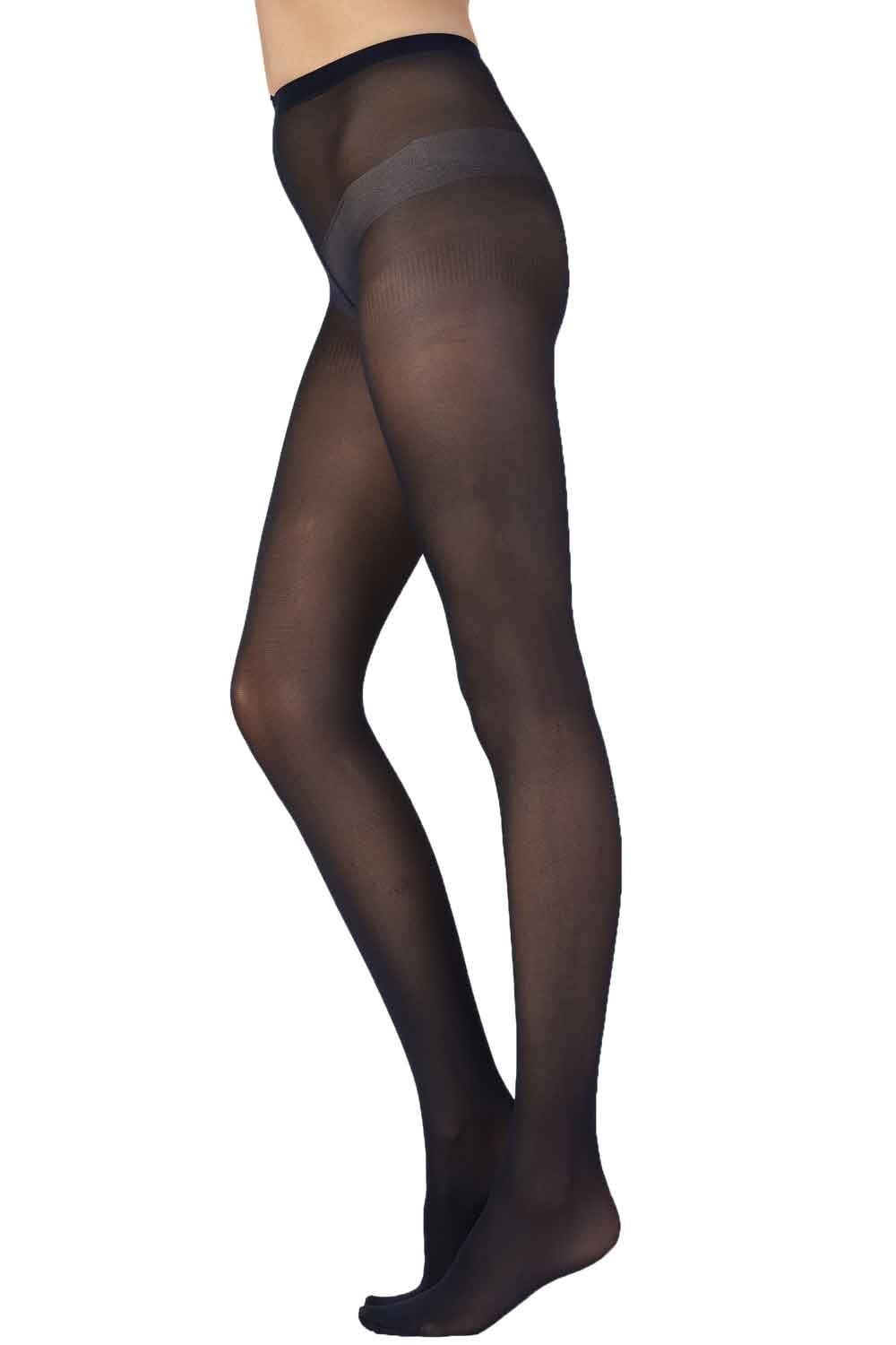 Black opaque  tights worn by a person on a white background