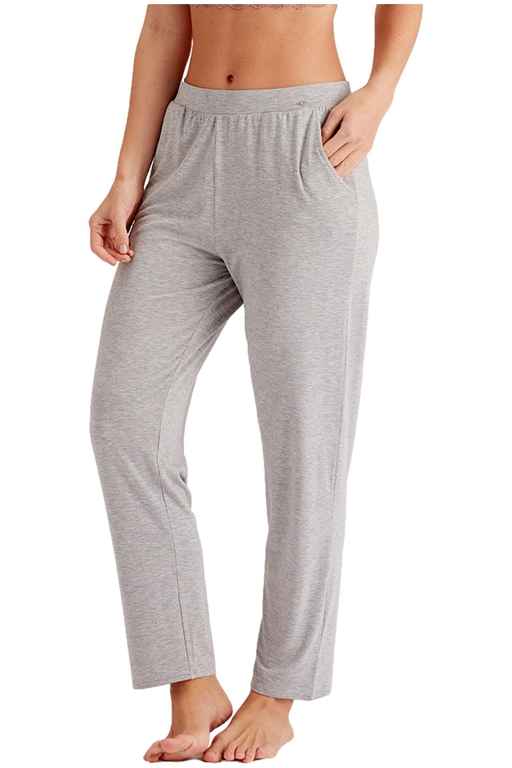 Gray joggers worn by a person on a white background