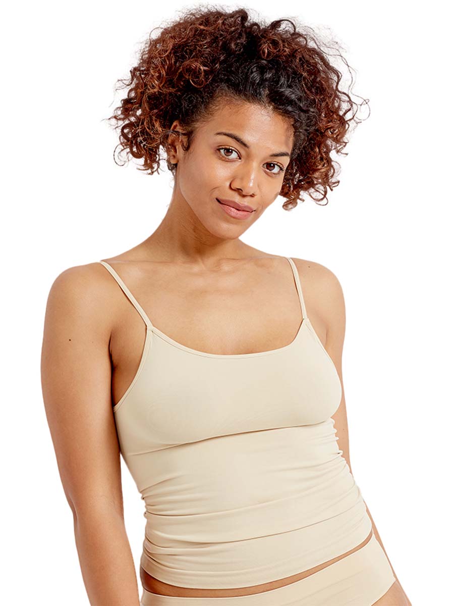 Woman wearing a nude cami vest  on a white background