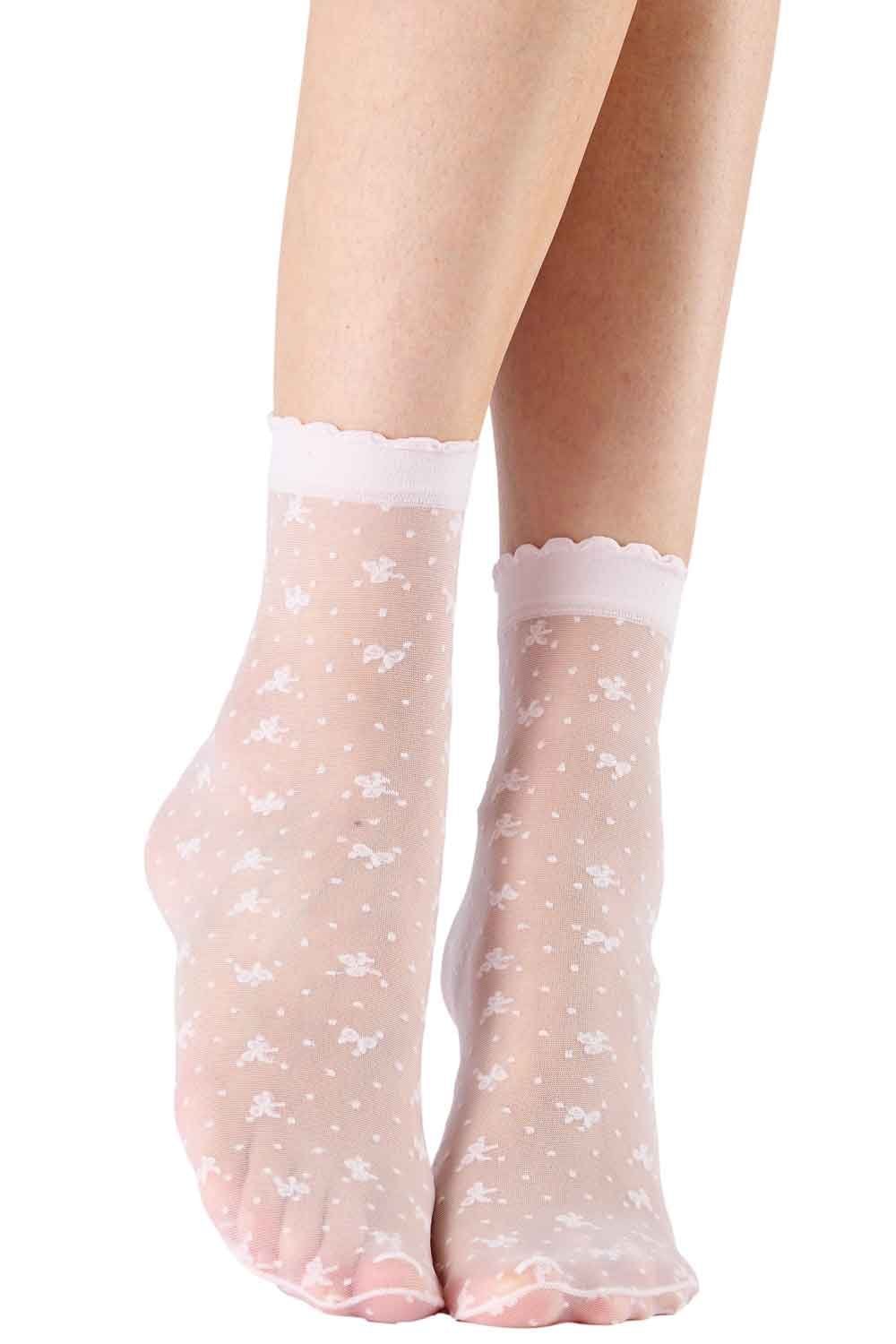 Sheer white  socks with white floral pattern worn by a person on a white background