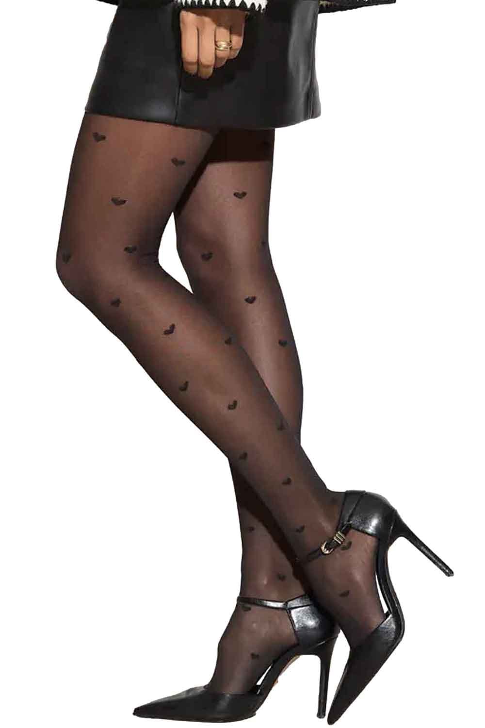 Black heart-patterned tights worn with black high-heeled shoes on a white background
