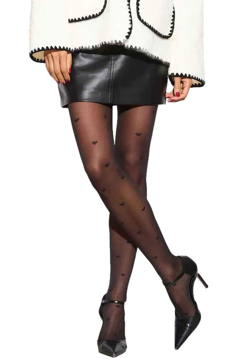 Model wearing black tights with heart patterns and black high-heeled shoes on a white background