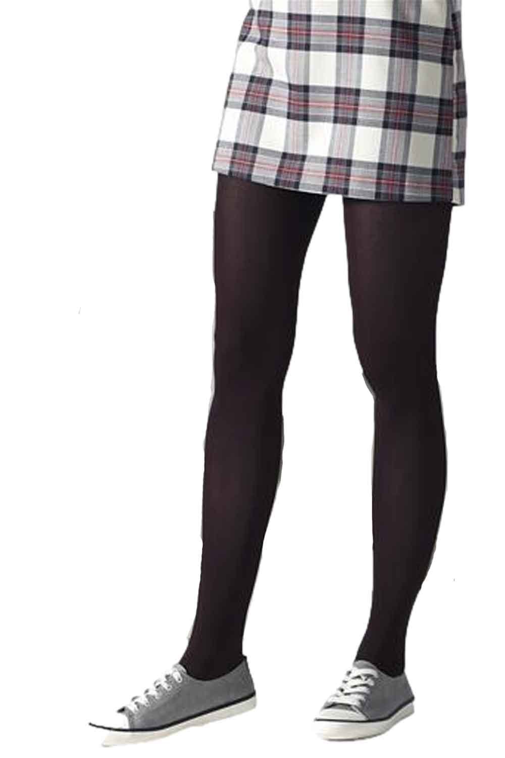 Model  wearing Gipsy shimmering tights, a plaid skirt, and gray shoes on a white background