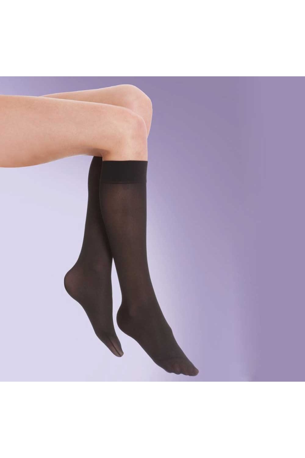Silky flight socks worn by a person on a light purple background