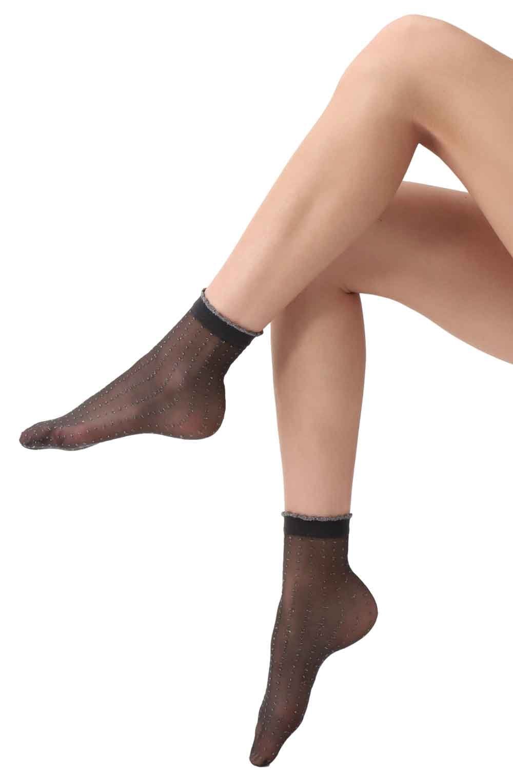 Black/gold socks  worn by a person on a white background