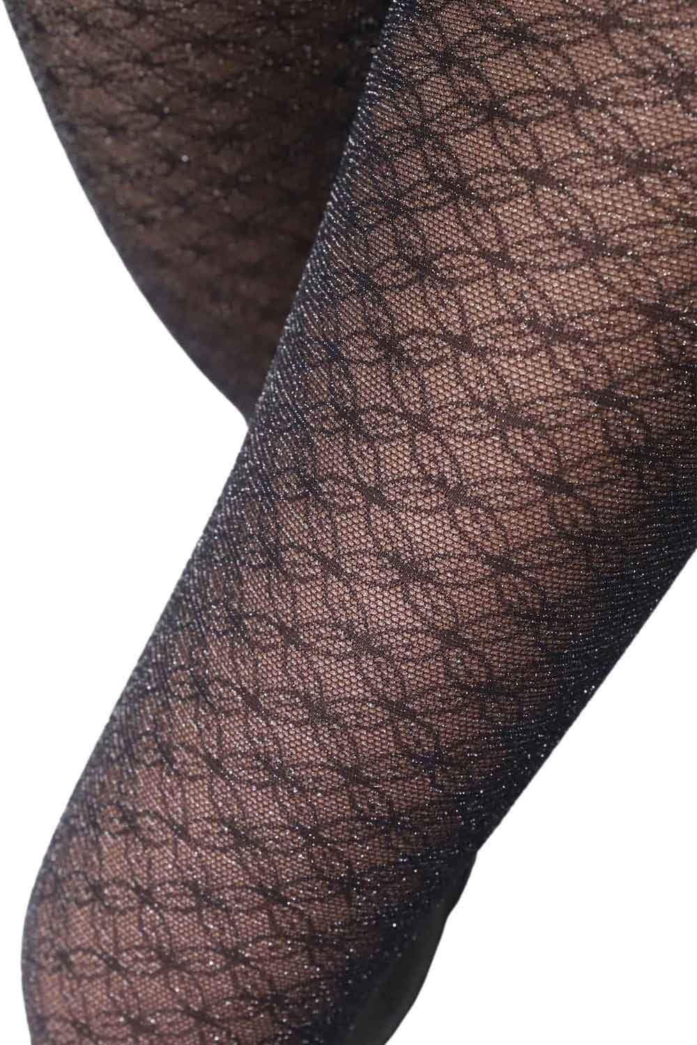 Close-up of black lace patterned  tights on a white background